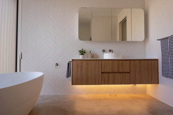 LED strip lighting beneath a floating timber bathroom vanity